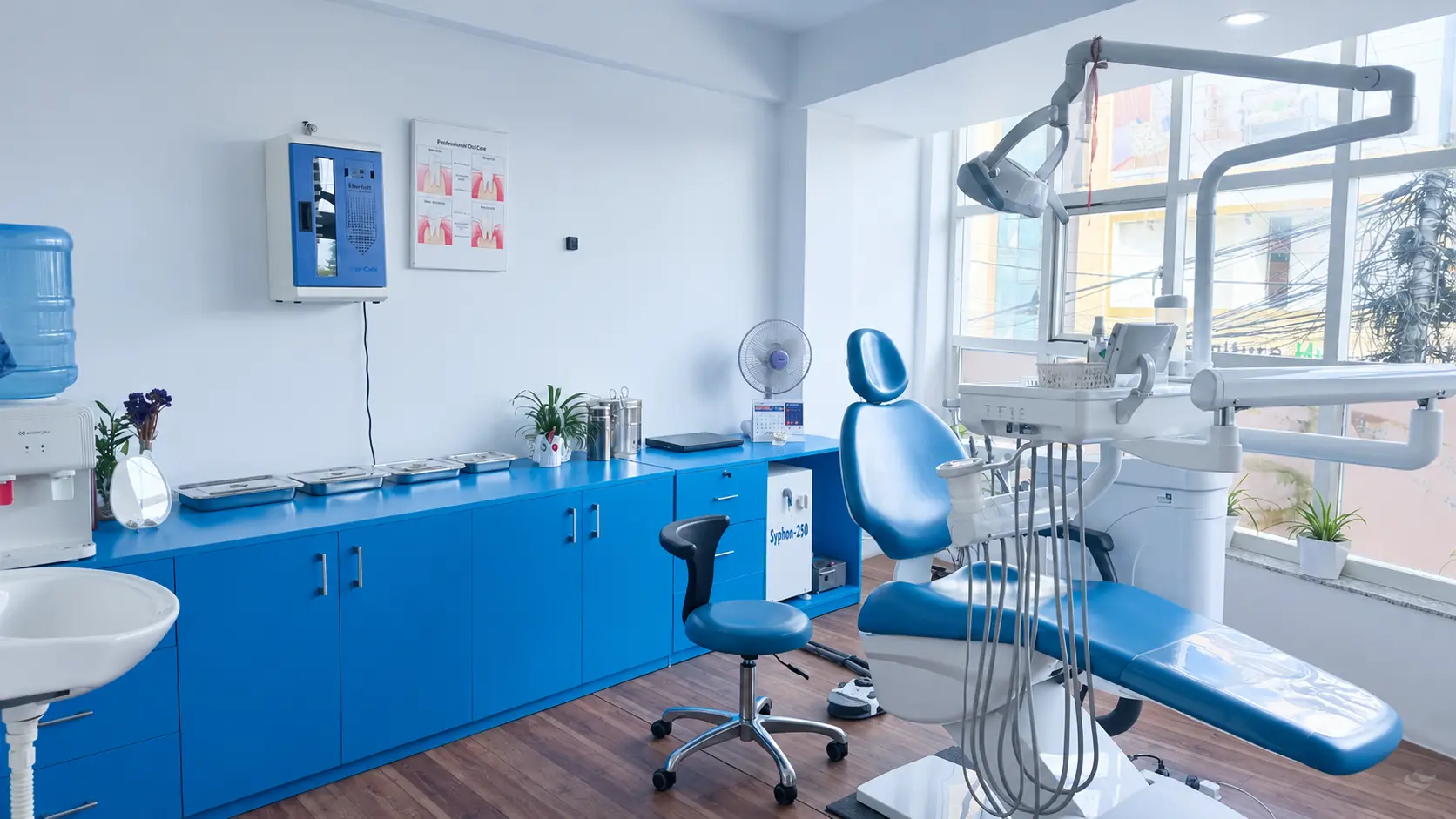 Dental treatment room with blue cabinets and a dental chair