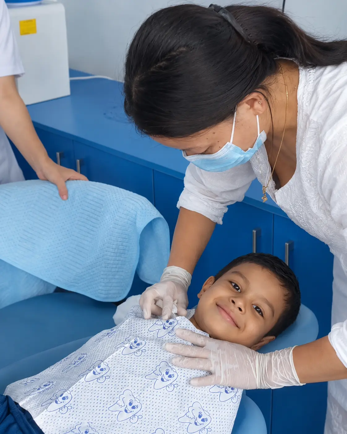 Dentist examining a smiling young patient